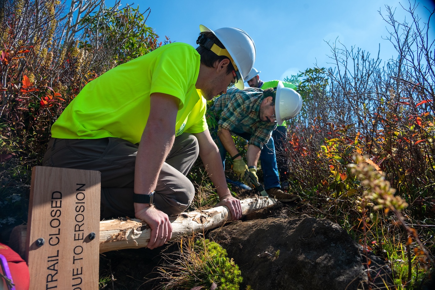 Volunteers installing a backcountry trail sign